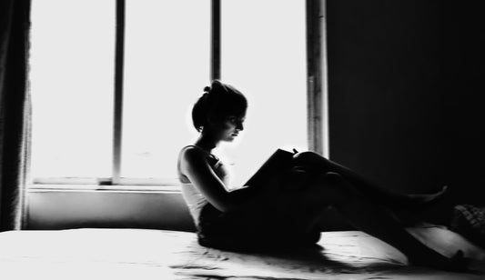 Woman in black tank top sitting on floor by Arghasree Banerjee