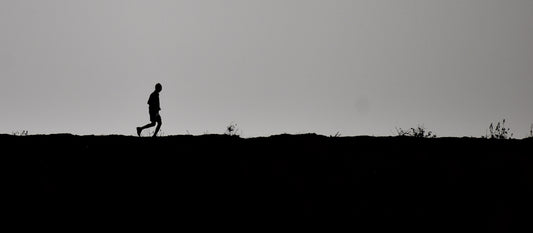 person running across barren landscape